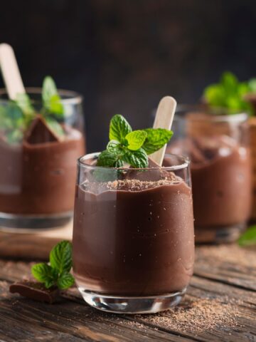 Sweet mousse with chocolate and mint on the rustic table, selective focus