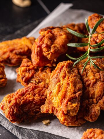 Buffalo style chicken wings served with cold beer on dark background