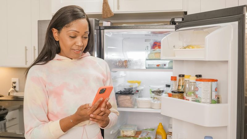 Woman in Hoodie Doing Online Grocery Shopping