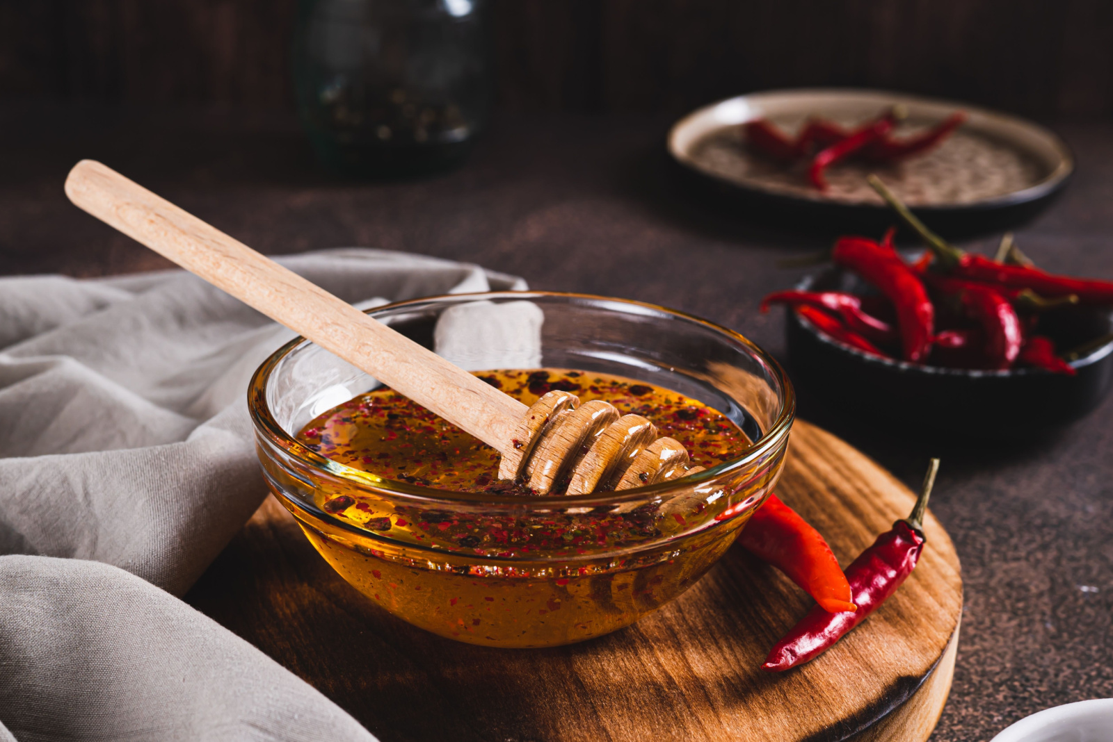 Hot honey chili sauce in bowl on table