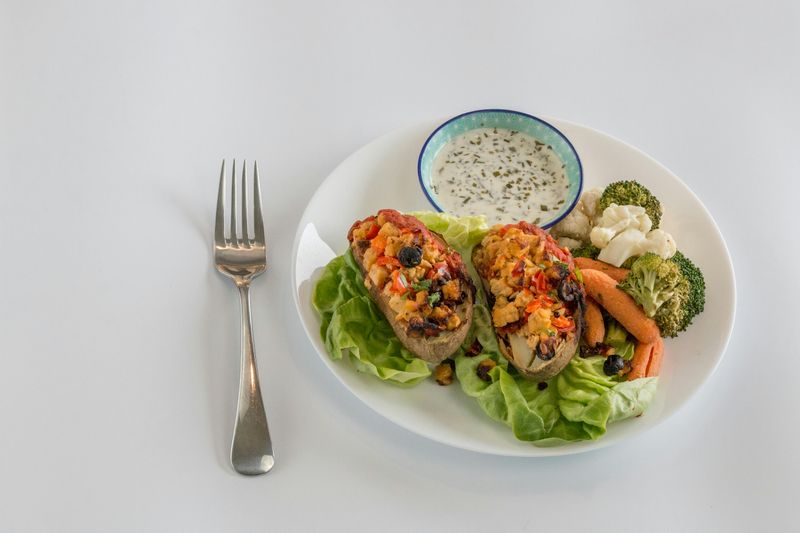 Toasts with Vegetables and Dip Served on White Plate