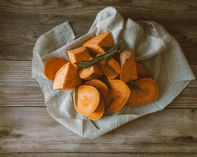 Overhead Shot of Chopped Sweet Potatoes on a Piece of Clot