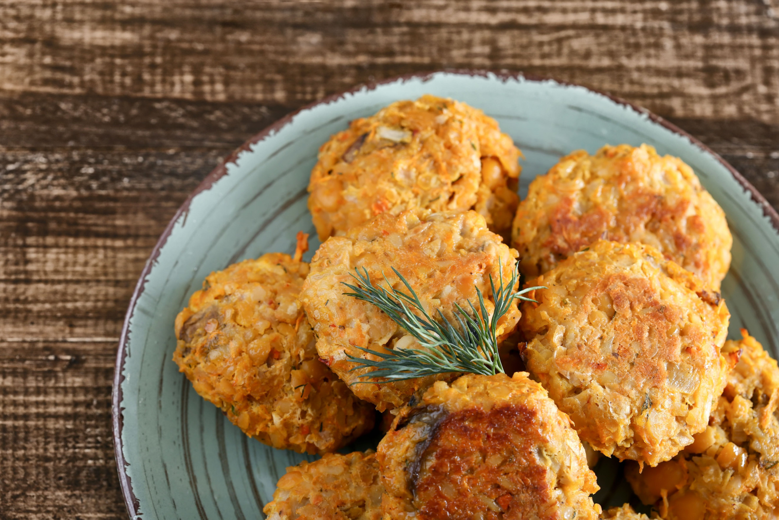 Useful vegan fried chickpea patties on a plate. Tasty and healthy vegetarian food on a wooden table