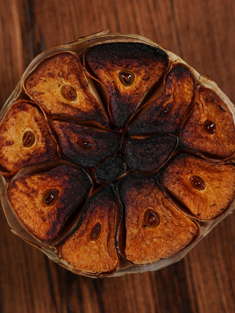Close-up of Roasted Garlic Bulb on Wooden Surface