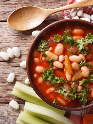 Homemade bean soup with ingredients. horizontal view from above