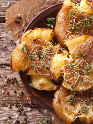 Australian food: crash hot potatoes with thyme and cheese on a plate close-up. horizontal view from above