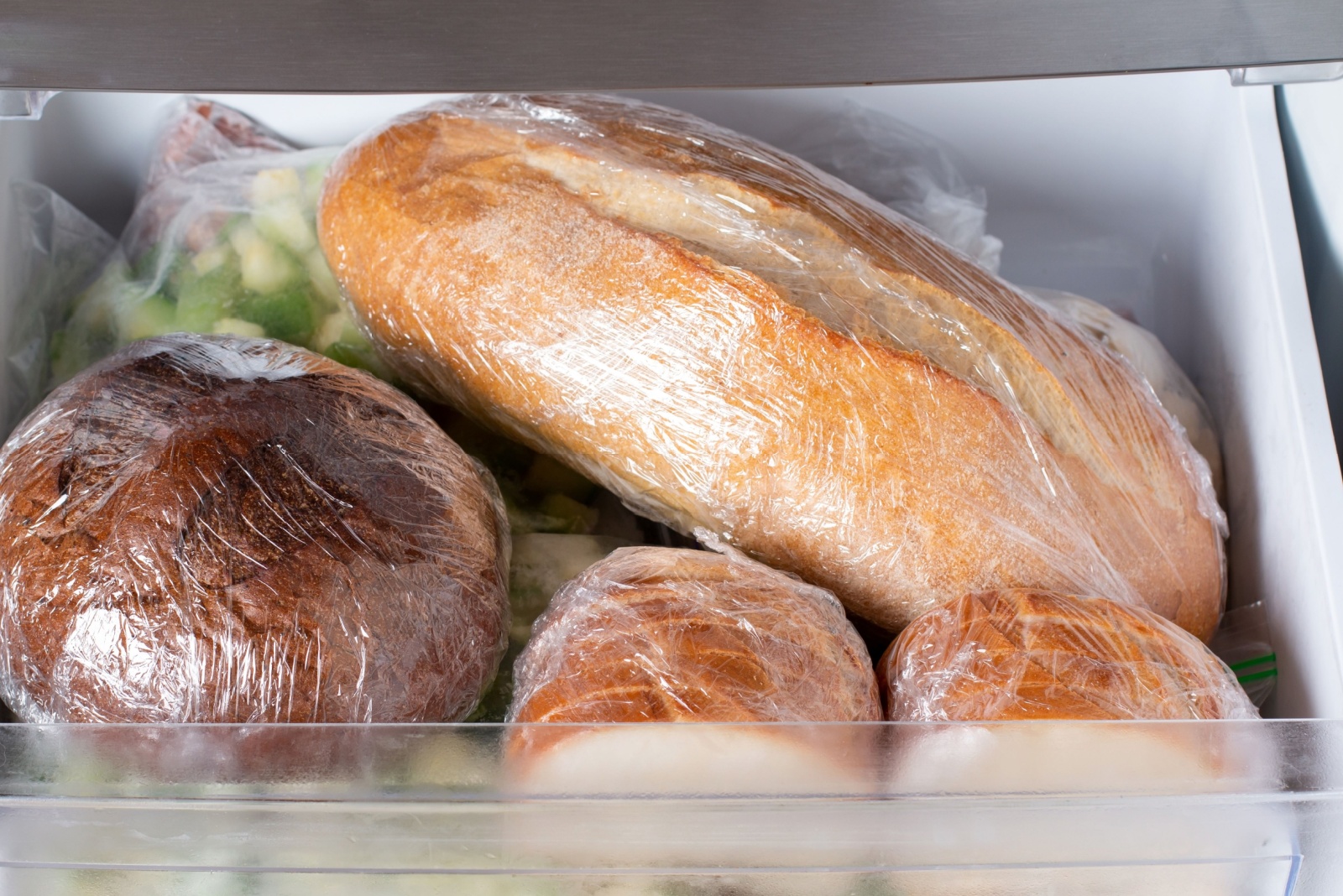 Frozen bread in the home freezer. Frozen bread: ciabatta, loaf, hamburger buns