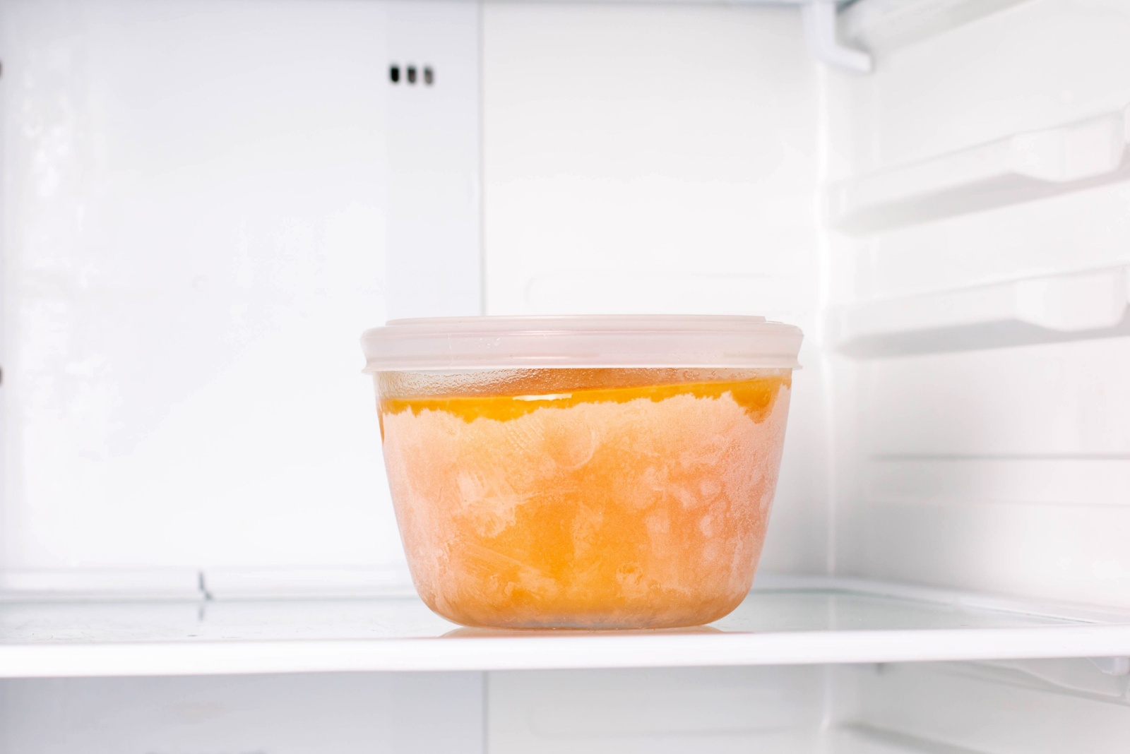 Frozen pumpkin soup in the refrigerator. Frozen food. Frozen soup. Preparing food for the week