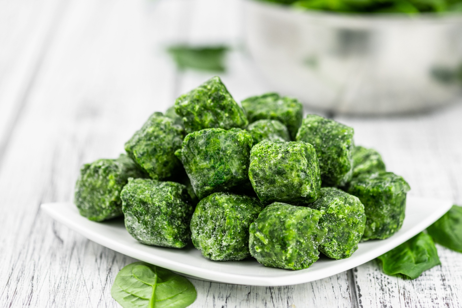 Frozen spinach cubes as detailed close up shot (selective focus)