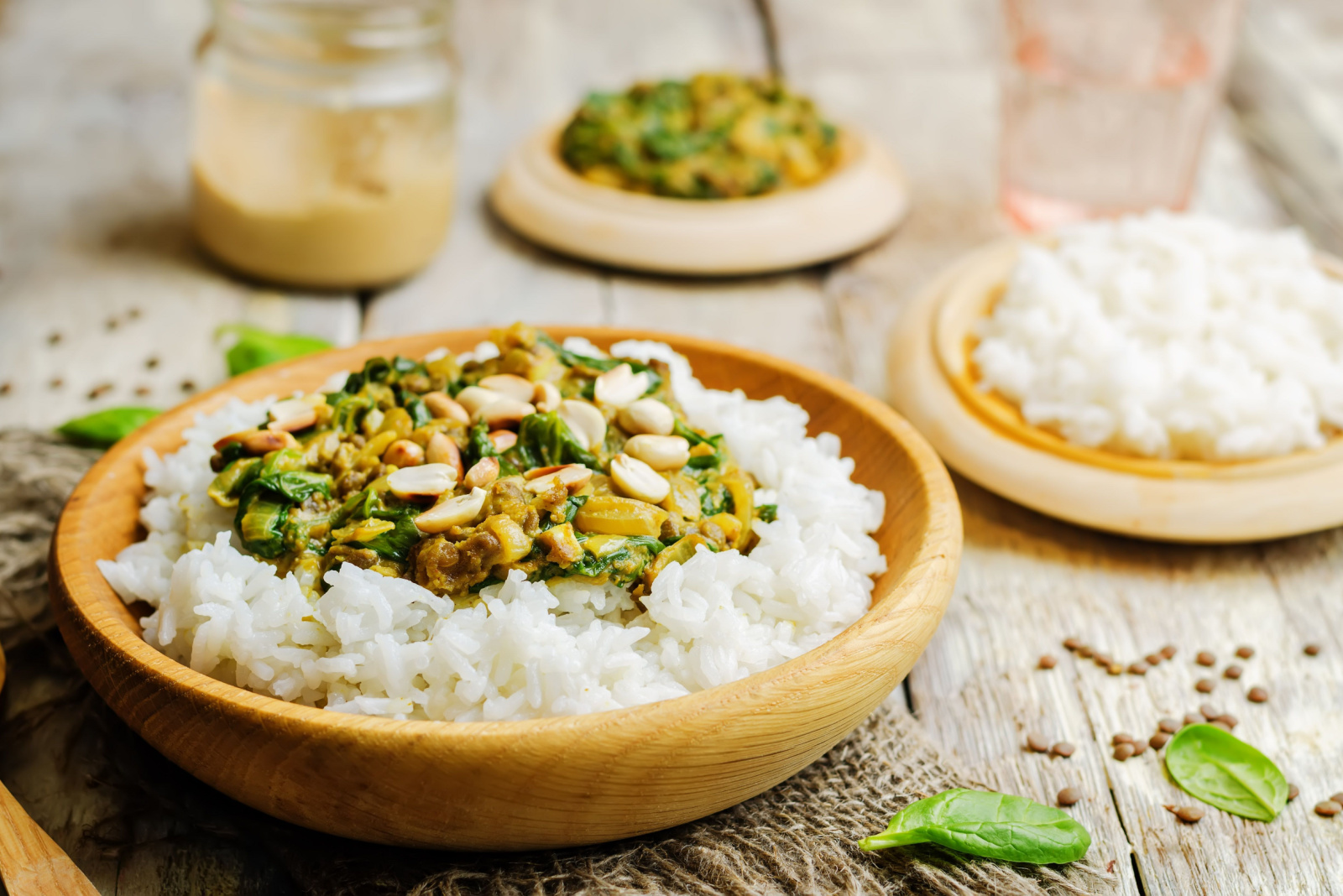 lentils, peanut butter spinach curry with rice on a wood background. toning. selective Focus
