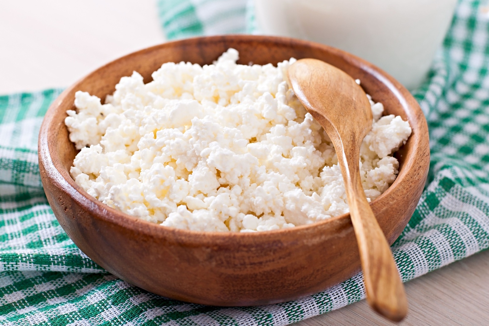 Cottage cheese with apples for breakfast in wooden bowl close up