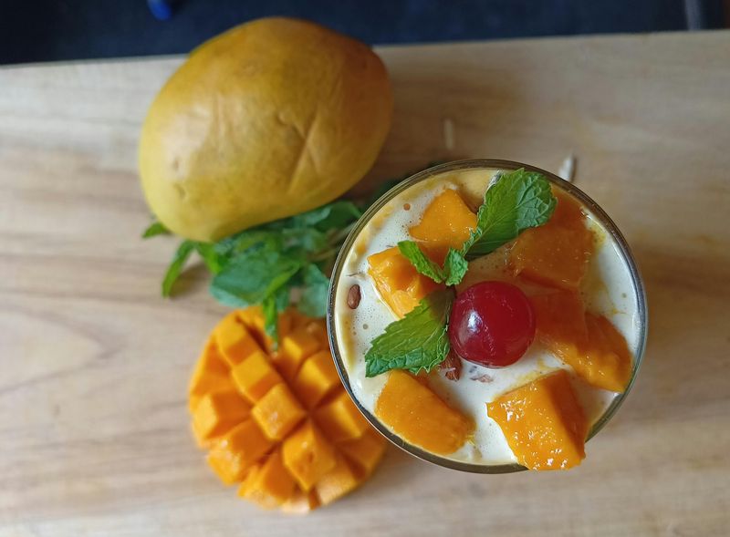 Mango Cocktail Set next to Cut up Mango Fruit