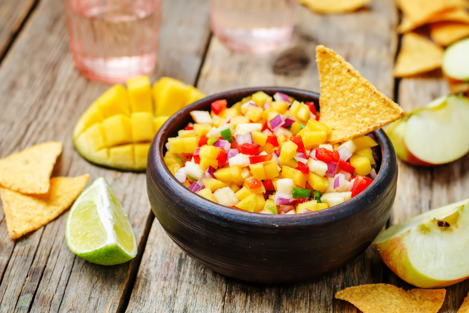 apple mango salsa on a dark wood background. toning. selective Focus