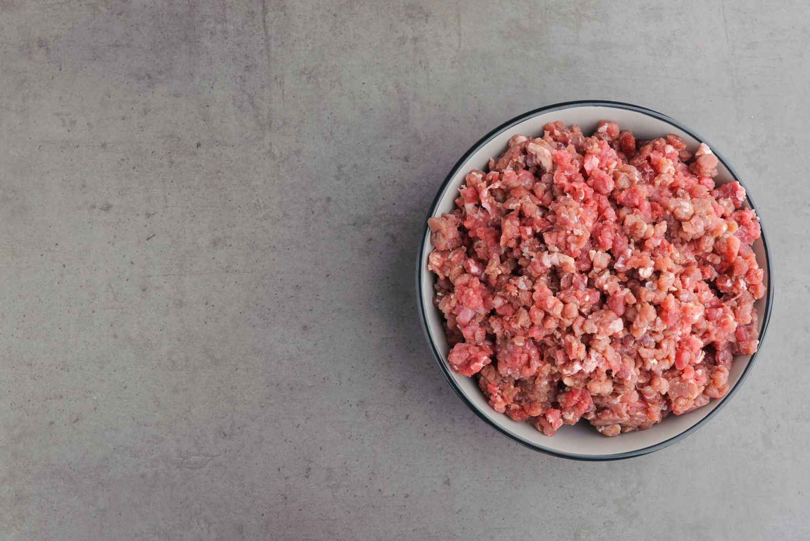 Natural raw ingredients for pet food on grey background. Flat lay.