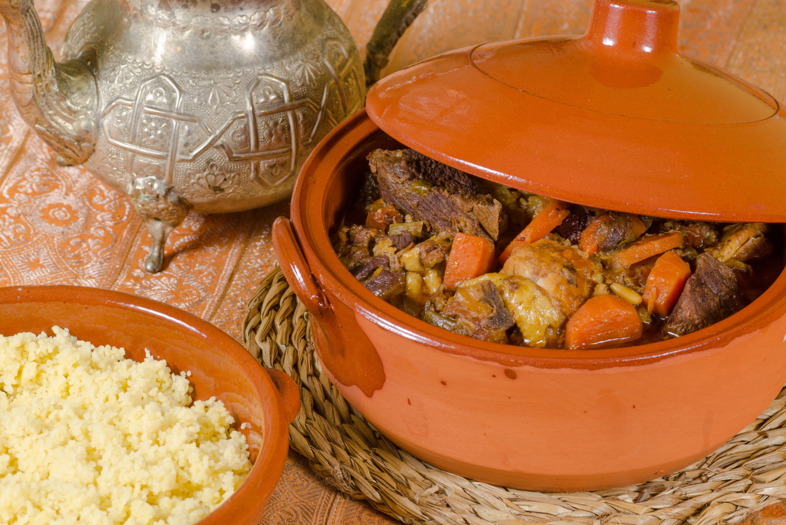 Closeup take of fresh couscous in traditional clay pots