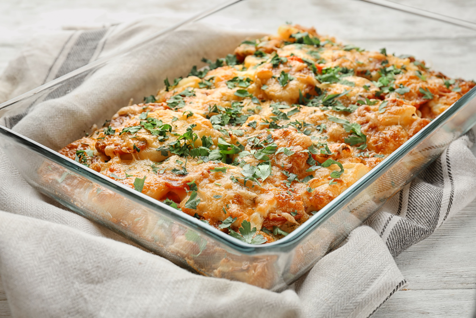 Delicious sausage casserole in baking dish on table