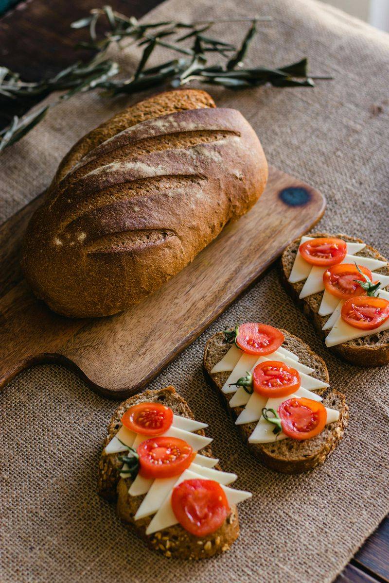 Rustic bread and tomato sandwiches on a cutting board