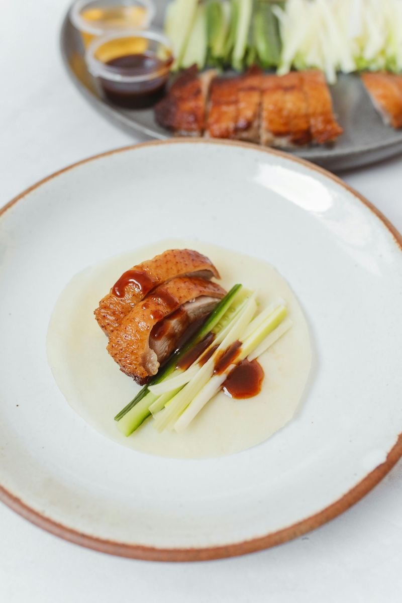 Close-up Photo of Savory Peking Duck Dish on a Ceramic Bowl