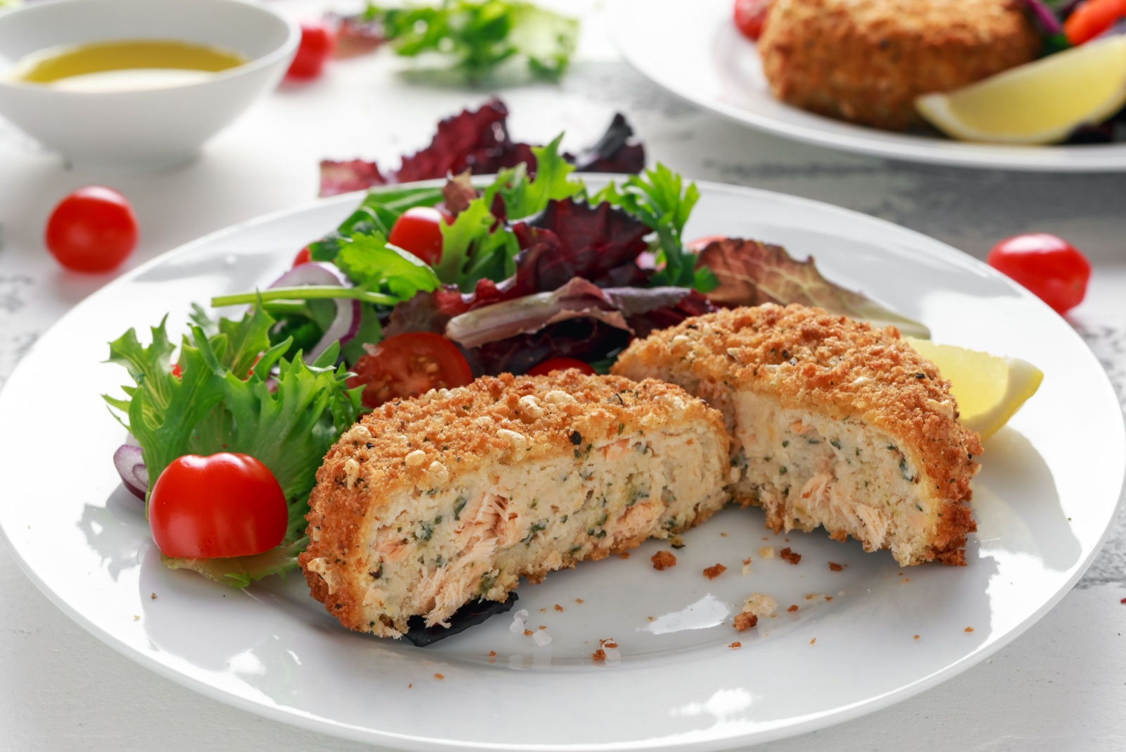 Home made Fish Cake salmon, spinach and potato. served on plate with vegetables