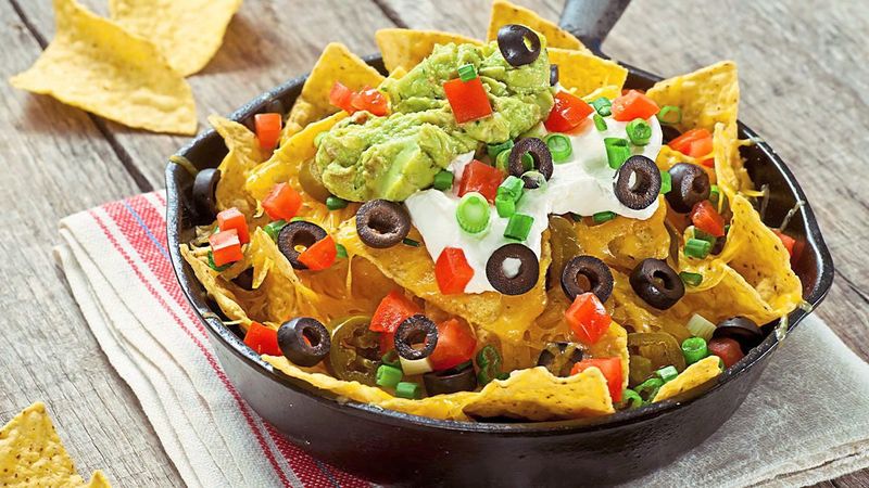 Cheesy Loaded Nachos With Guacamole And Salsa
