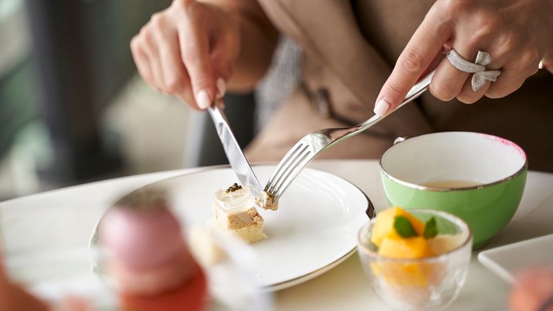 Using The Fork In The Left Hand And Knife In The Right