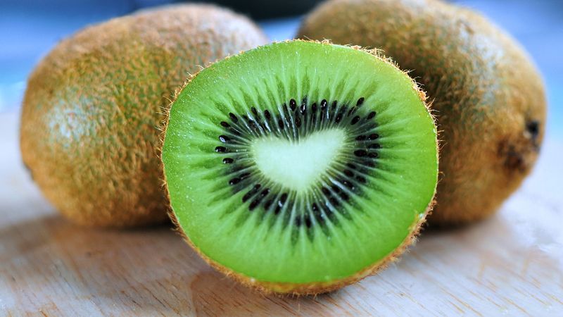 Choosing Between Red And Green Kiwi At The Shop