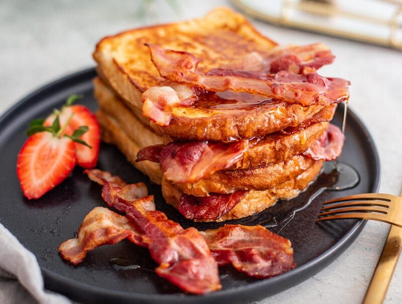French Toast Served With Bacon And Maple Syrup