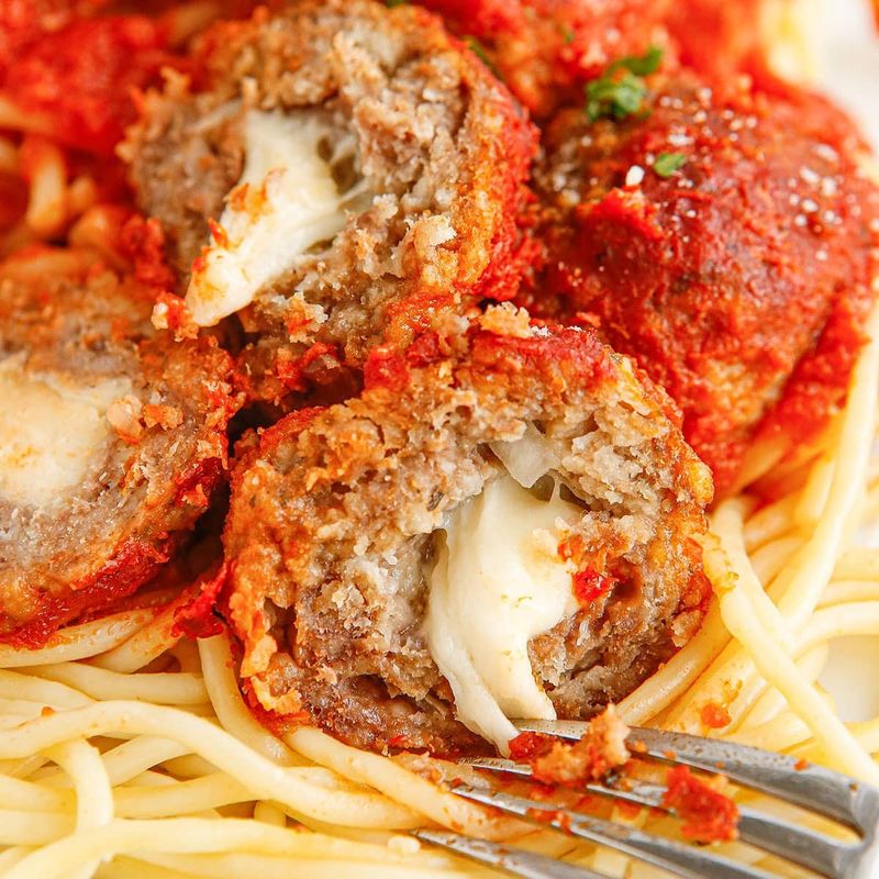 Cheese-Stuffed Meatballs Over Pasta