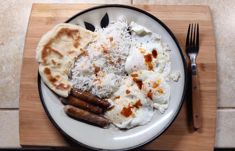Sriracha Drizzled Over Scrambled Eggs and Sausages