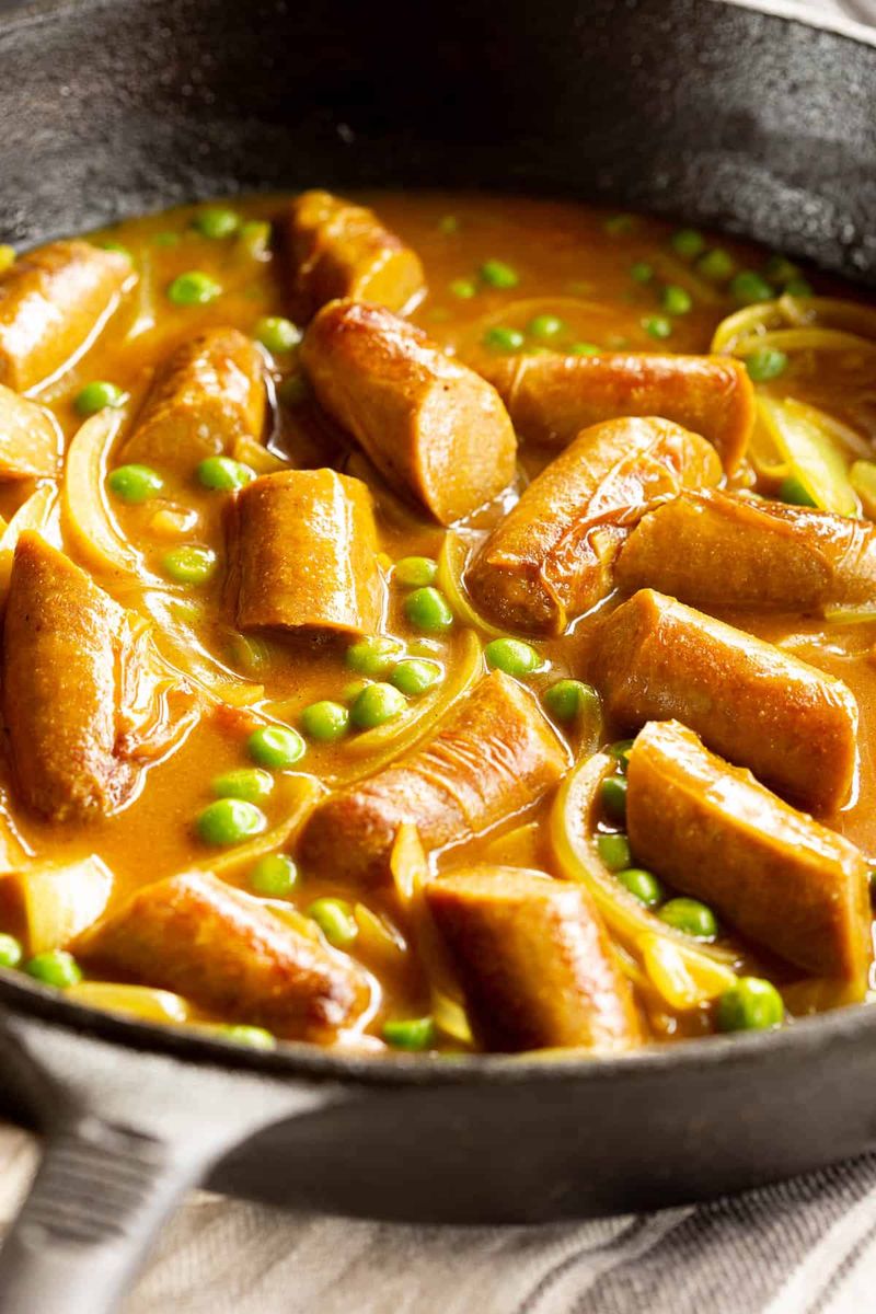 Curry Sauce Poured Over Sausages and Beans