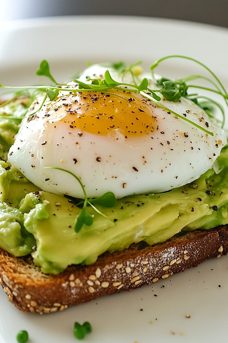 Poached Eggs Over Avocado Toast with Microgreens
