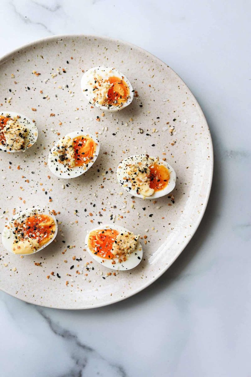 Boiled Eggs Sprinkled with Everything Bagel Seasoning and Hot Sauce