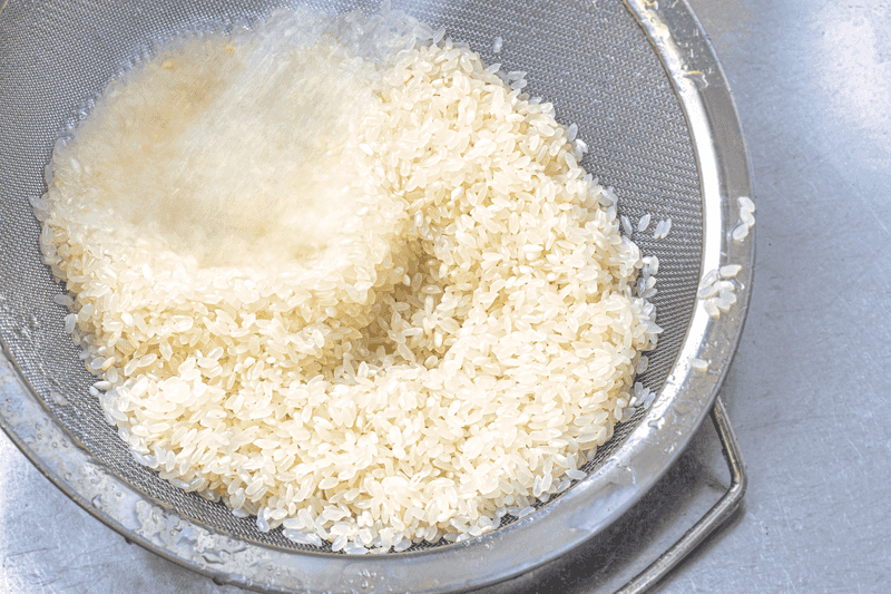 Cook Rice with Less Starch by Rinsing It First