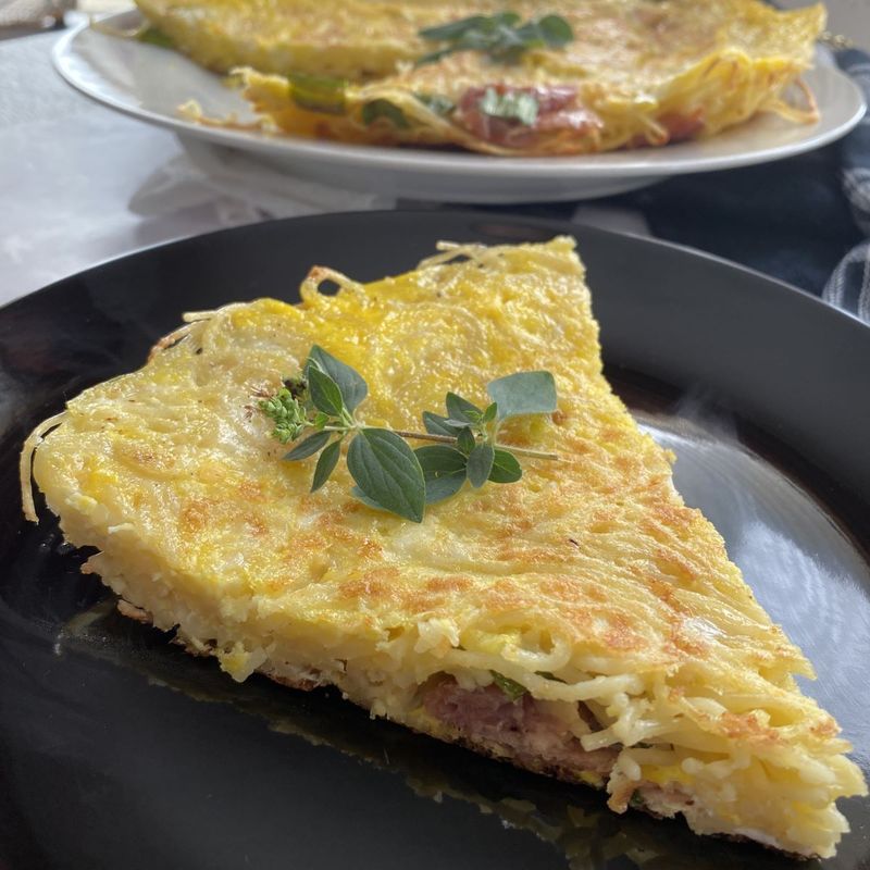 Spaghetti Frittata Slice with Sun-Dried Tomatoes and Parmesan