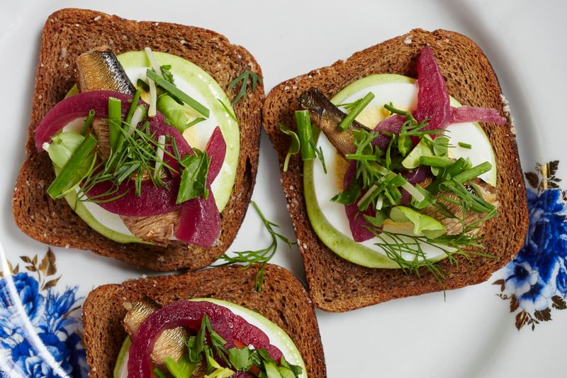 Sprats on Dark Rye with Pickled Onions