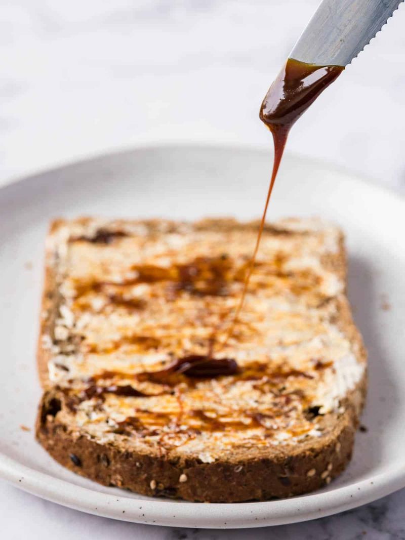 Spreading Marmite on Toast