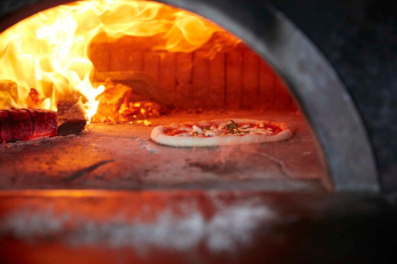 Watching a Wood-Fired Pizza Go Into the Oven